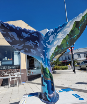 WHALES TAILS SURFACING IN THE VILLAGE AS PART OF a